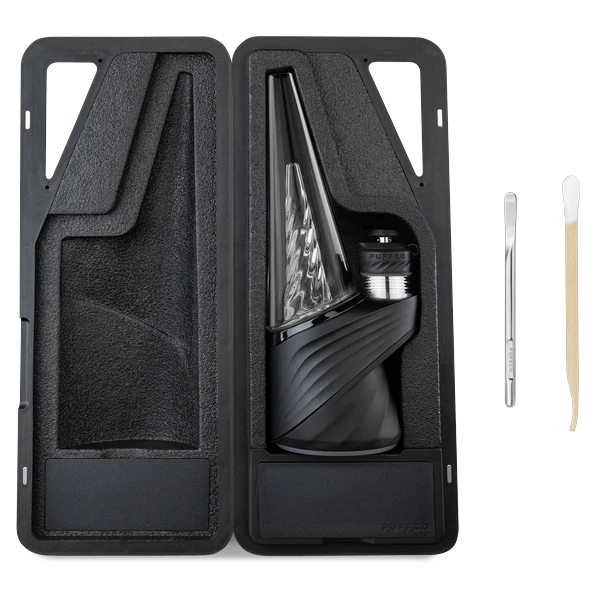 Puffco Peak Pro 3DXL in Onyx inside its open carrying case, with the metal loading tool and a Puffco Dual Tool beside it
